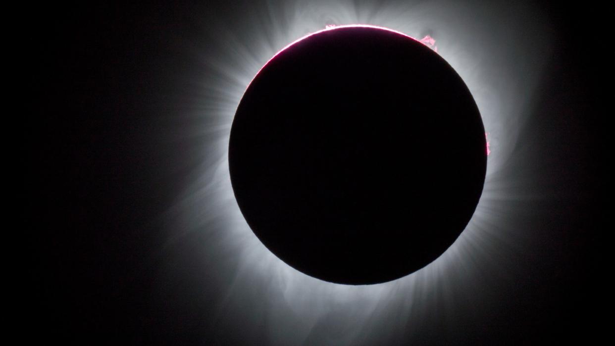  A total solar eclipse seen against a black sky. 
