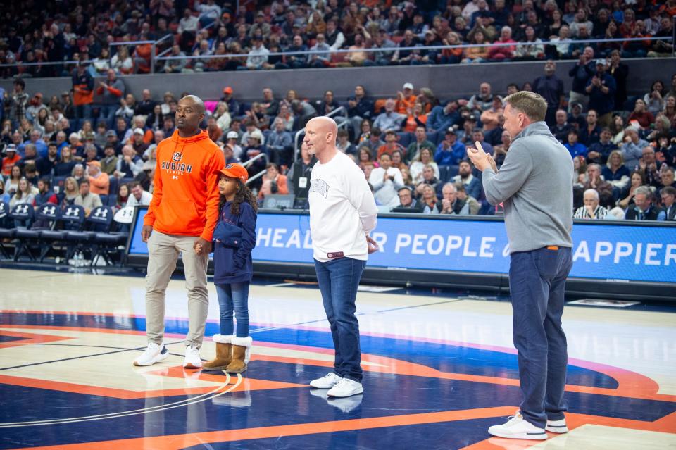 New Auburn Tigers football offensive coordinator Derrick Nix, from left, defensive coordinator Charles Kelly and head coach Hugh Freeze are introduced as Auburn Tigers basketball takes on Ole Miss Rebels at Neville Arena in Auburn, Ala., on Saturday, Jan. 20, 2024.
