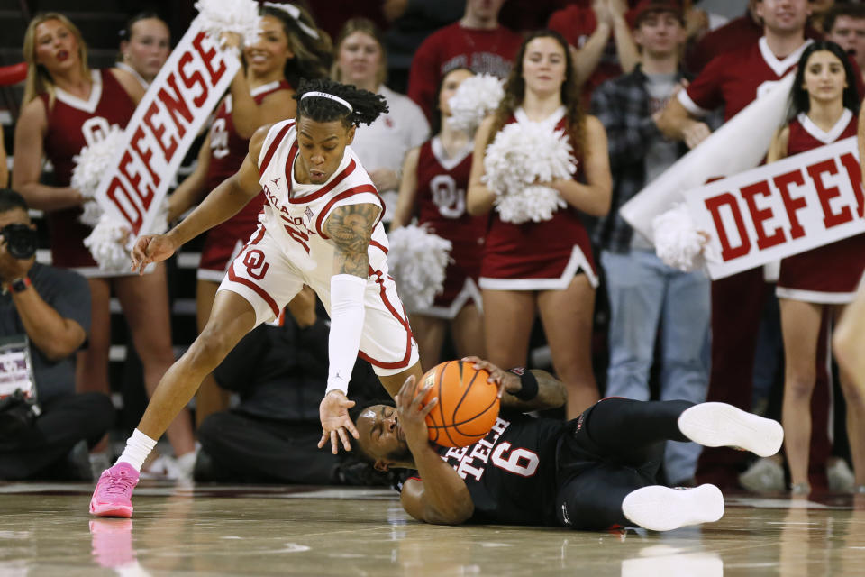 Texas Tech guard Joe Toussaint (6) grabs the ball as Oklahoma guard Javian McCollum (2) reaches for it during the second half of an NCAA college basketball game, Saturday, Jan. 27, 2024, in Norman, Okla. (AP Photo/Nate Billings)