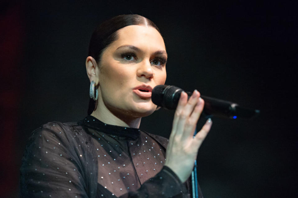 A closeup of jessie singing onstage