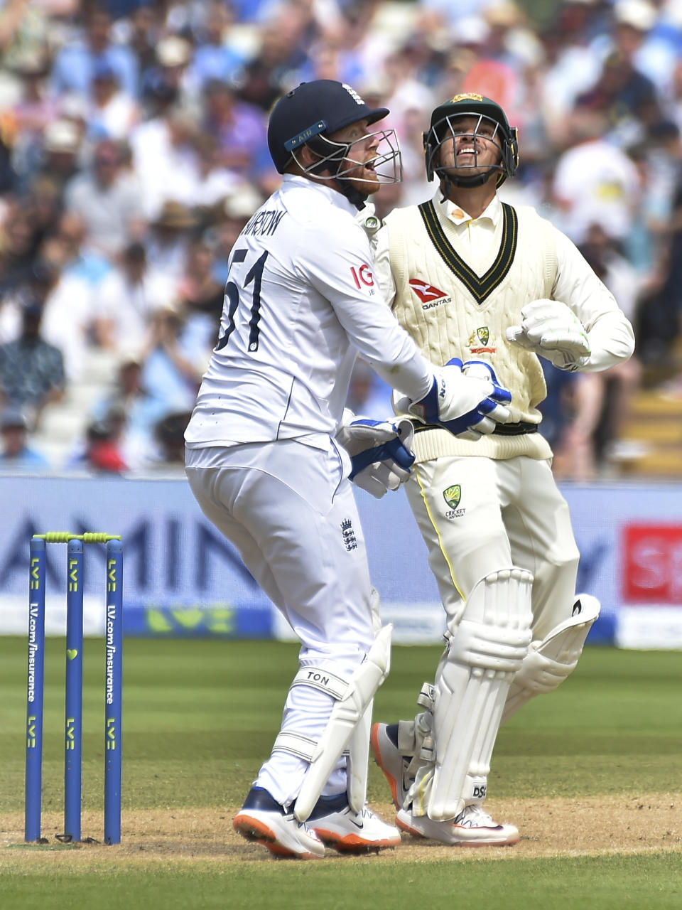 Australia's Usman Khawaja, right, and England's Jonny Bairstow react during day two of the first Ashes Test cricket match between England and Australia at Edgbaston, Birmingham, England, Saturday, June 17, 2023. (AP Photo/Rui Vieira)