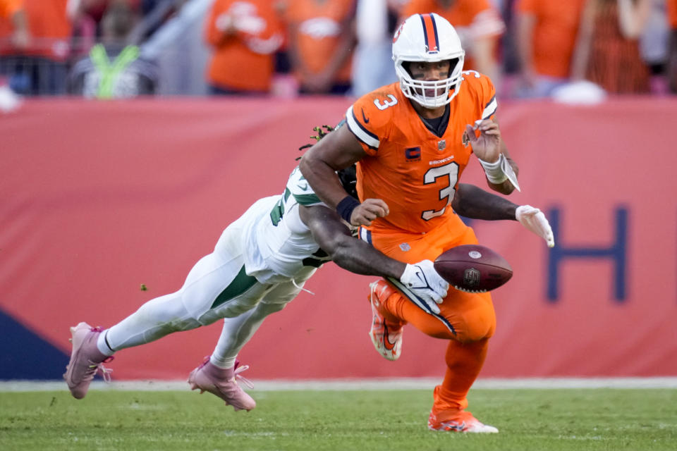 New York Jets linebacker Quincy Williams forces of humble by Denver Broncos quarterback Russell Wilson during the second half of an NFL football game Sunday, Oct. 8, 2023, in Denver. (AP Photo/David Zalubowski)