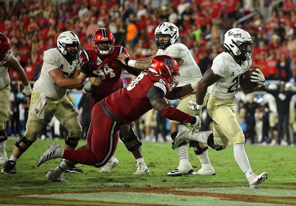 UCF running back RJ Harvey scored a 3-yard touchdown against Florida Atlantic, his first career score for the Knights.