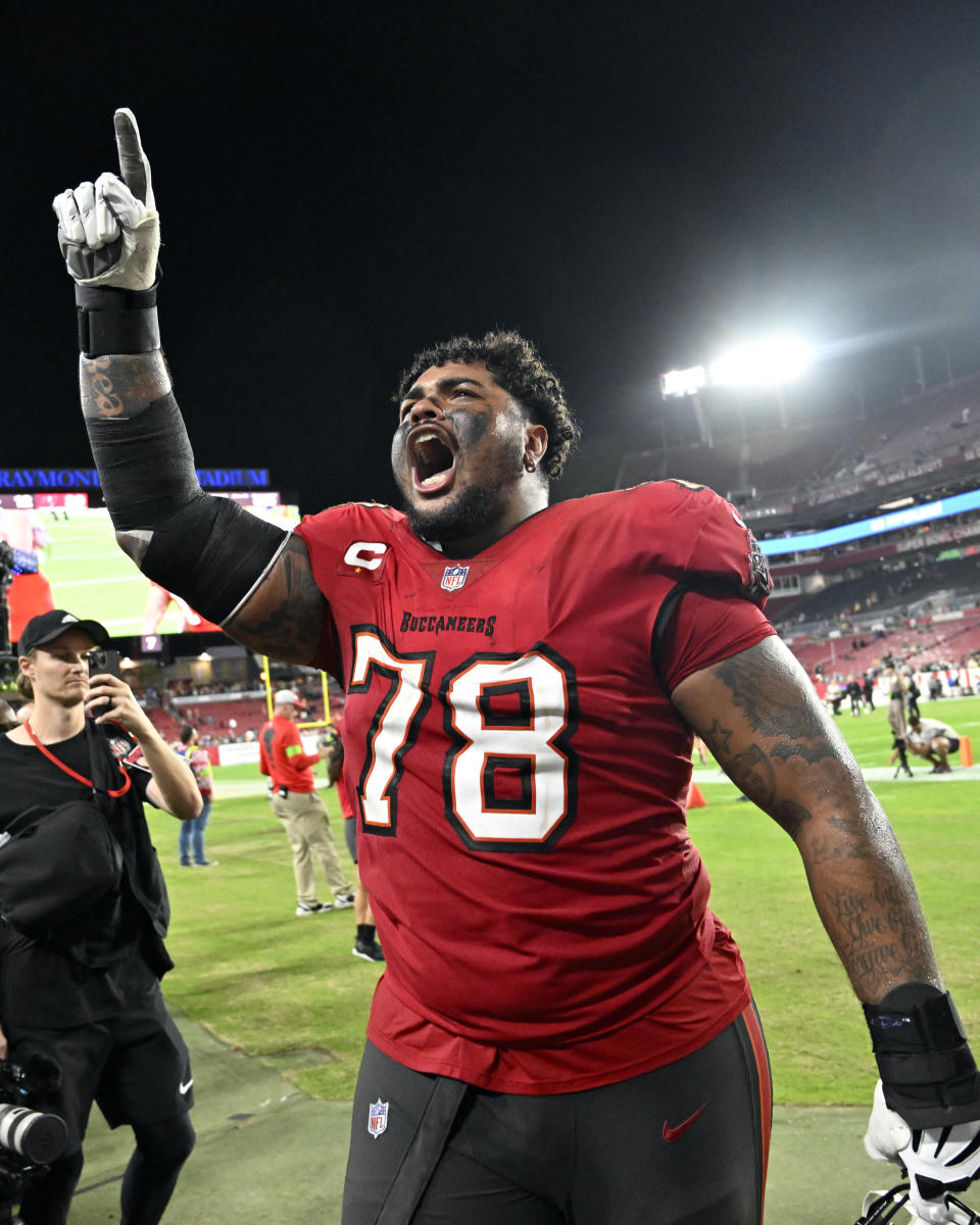 Tampa Bay Buccaneers offensive tackle Tristan Wirfs celebrates with fans as he leave the field after defeating the Jacksonville Jaguars in an NFL football game Sunday, Dec. 24, 2023, in Tampa, Fla. (AP Photo/Jason Behnken)