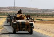 A Turkish army convoy drive from the border back to their base in Karkamis on the Turkish-Syrian border in the southeastern Gaziantep province, Turkey, August 27, 2016. REUTERS/Umit Bektas