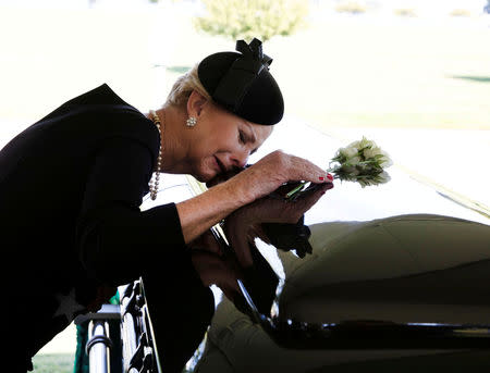 Cindy McCain lays her head on the casket of Sen. John McCain, R-Ariz., during a burial service at the cemetery at the United States Naval Academy in Annapolis, Md., on Sunday, Sept. 2, 2018. David Hume Kennerly/McCain Family/Pool via Reuters