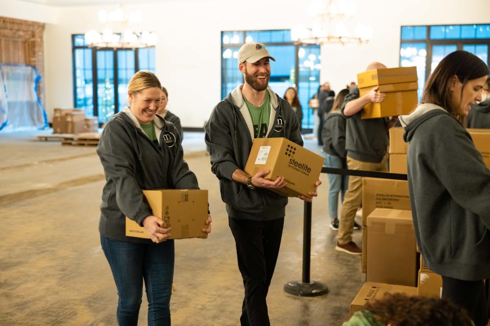 Volunteers from mDesign help set up storage and organizational equipment at The LeBron James Family Foundation's House Three Thirty in Akron.