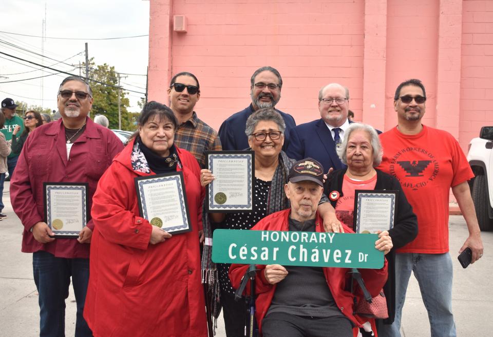 Five Adrian proclamations were presented Thursday to individuals and families who continue to advocate for the rights of migrant and farm workers. Those who received proclamations gathered with other advocates for the migrant working community outside of Veronica's Market at East Beecher and Gulf streets. They are, from left, Rudy Flores, Maria Jiamez, Carlos Casanova, Ben Negron (standing in the back row), Eva Hyder (middle row holding proclamation), Steve Hyder (seated), Maggie DeLeon, former Adrian Mayor Chuck Jacobsen and Leonard Garcia (far right).