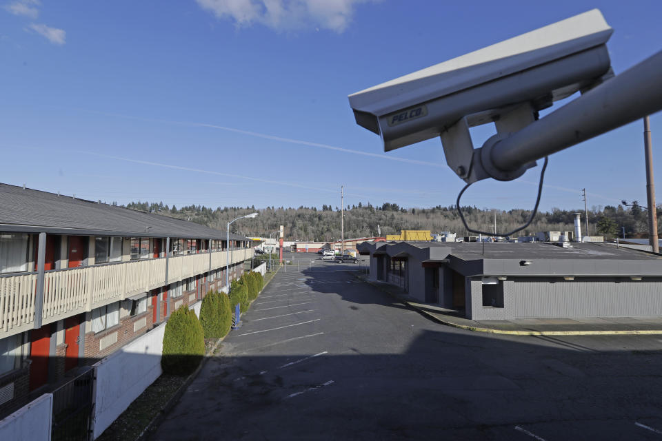 A security camera is shown on the second floor of a row of rooms at an Econo Lodge motel in Kent, Wash., Wednesday, March 4, 2020. King County Executive Dow Constantine said Wednesday that the county had purchased the 85-bed motel south of Seattle to house patients for recovery and isolation due to the COVID-19 coronavirus. (AP Photo/Ted S. Warren)