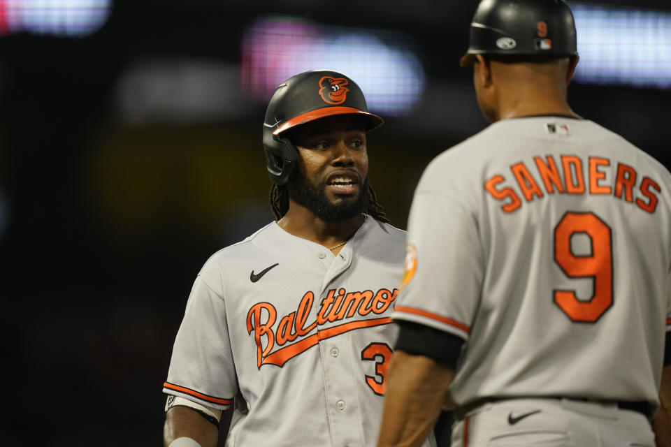 Baltimore Orioles shortstop Jorge Mateo (3) talks to Baltimore Orioles first base coach Anthony Sanders (9) at the top of the fourth inning of a baseball game against the Los Angeles Angels, Monday, Sept. 4, 2023, in Anaheim, Calif. (AP Photo/Ryan Sun)