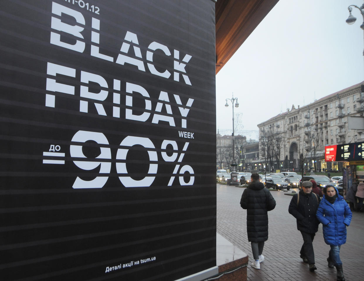 Shoppers walk past a Black Friday sales board. (Alexey Ivanov/SOPA Images/Sipa USA)