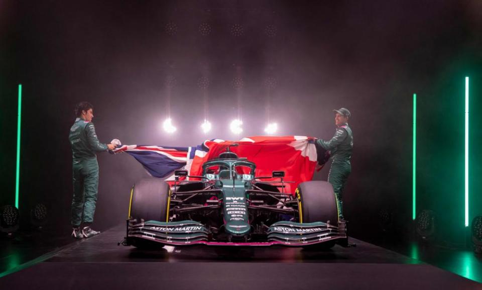 Lance Stroll and Sebastian Vettel pull back a union jack to unveil Aston Martin’s car for the 2021 season.