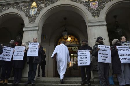 A member of the continuing praying presence enters The Church House during a vigil against Anglican Homophobia, outside the General Synod of the Church of England in London, Britain, February 15, 2017. REUTERS/Hannah McKay