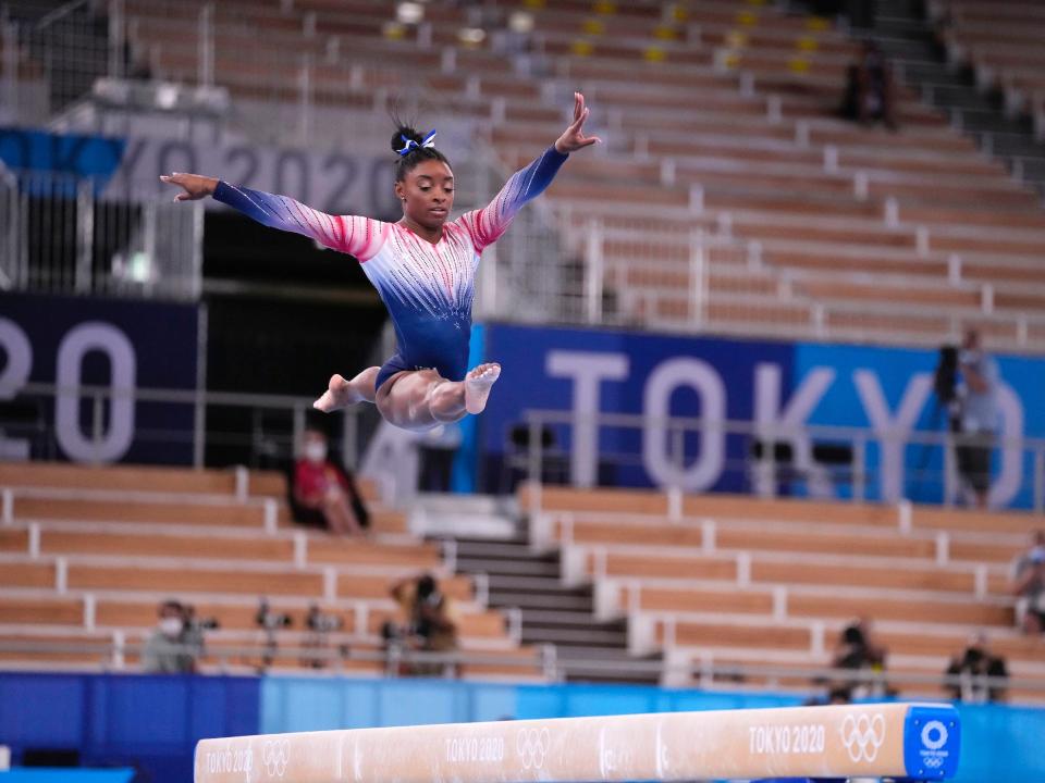 Simone Biles performs on the balance beam.