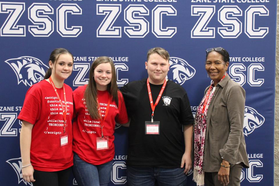 Licking Valley sisters Maya and Taya Sensabaugh (left) are shown with Jacob Keffer of Tri-County Career Center and their mentor, Deborah Maldonado of Wisdom Works Institute, during the TECH CORPS Hackathon at Zane State College.