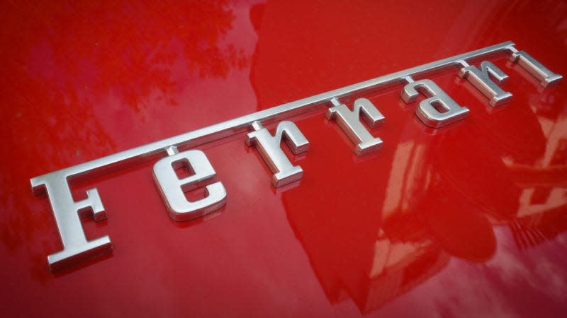 A close up photo of the Ferrari logo on a vintage sports car. 