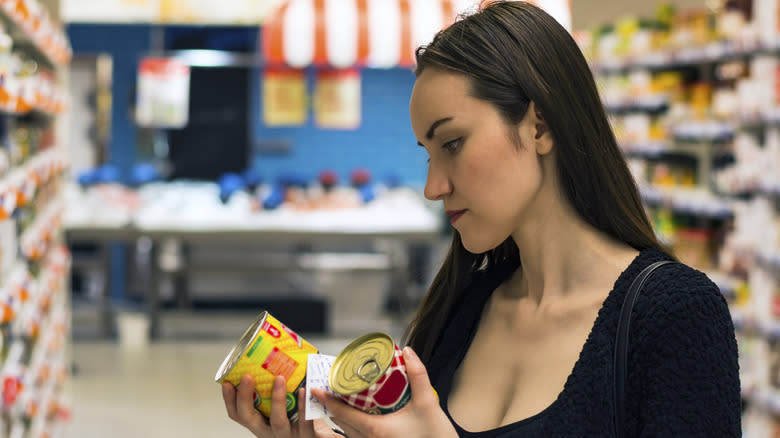 Woman choosing canned corn