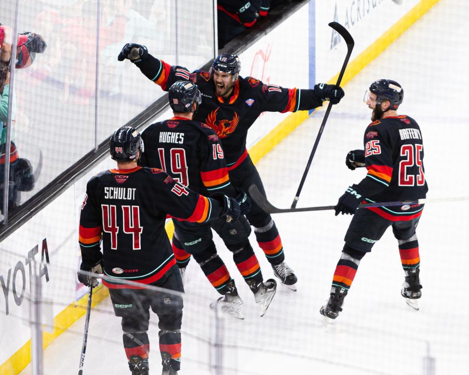 Cameron Hughes (#19) celebrates with a teammate after scoring a goal during Game 2 of the AHL Calder Cup Finals between the Coachella Valley Firebirds and the Hershey Bears at Acrisure Arena in Palm Desert, CA on June 10, 2023.