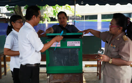 Officials inspect empty ballot boxes at a polling station ahead of the general election in Bangkok, Thailand, March 24, 2019. REUTERS/Soe Zeya Tun