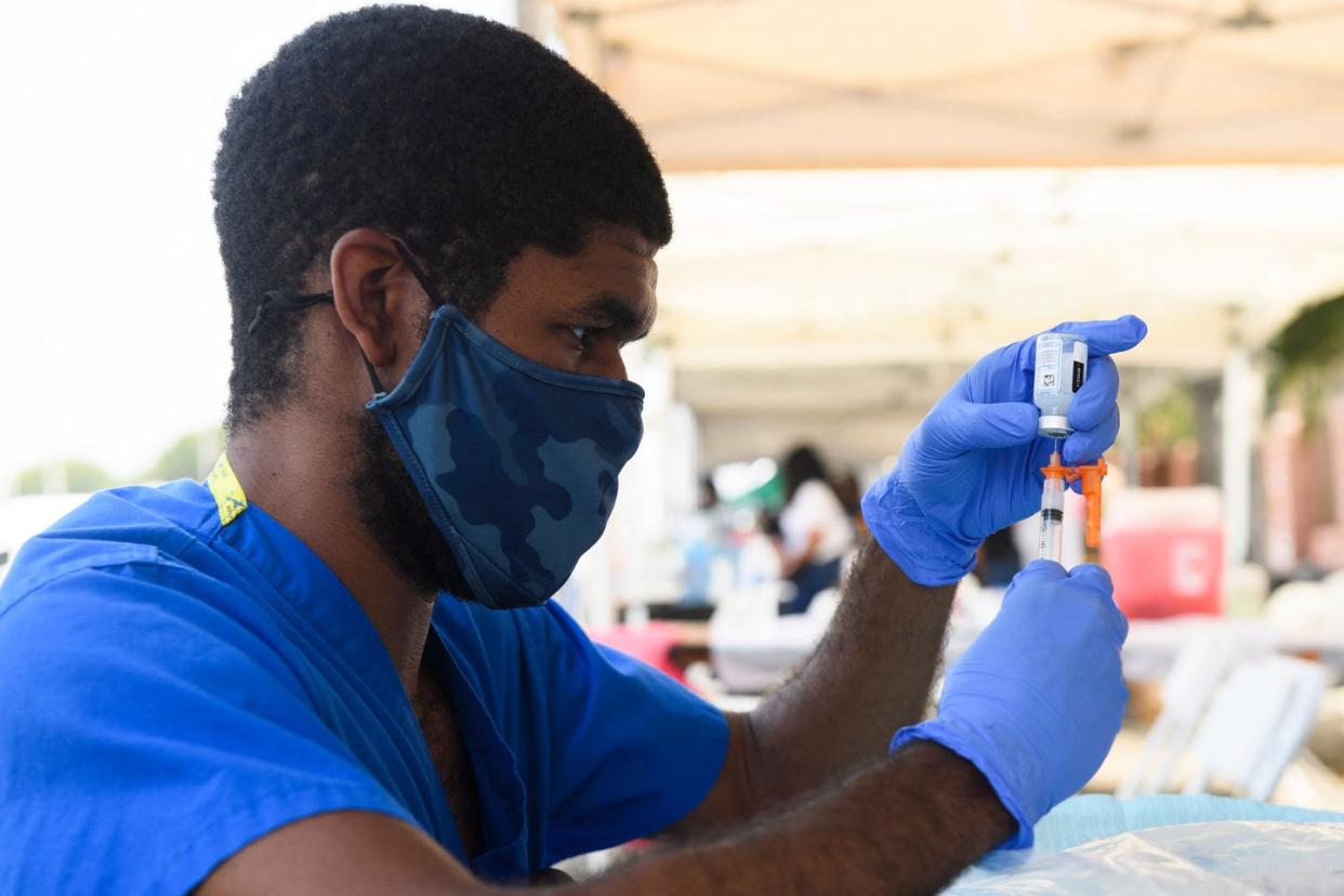 <span class="caption">The best way to stop a contagious virus like COVID-19 is through a worldwide vaccination program.</span> <span class="attribution"><a class="link " href="https://www.gettyimages.com/detail/news-photo/health-care-worker-prepares-a-dose-of-the-moderna-covid-19-news-photo/1233550859?adppopup=true" rel="nofollow noopener" target="_blank" data-ylk="slk:Patrick T. Fallon/AFP via Getty Images;elm:context_link;itc:0;sec:content-canvas">Patrick T. Fallon/AFP via Getty Images</a></span>