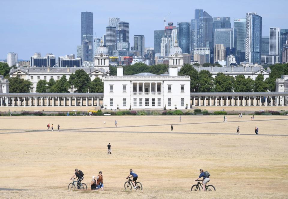 6 August 2022: People walk on parched ground in Greenwich Park in London (EPA)