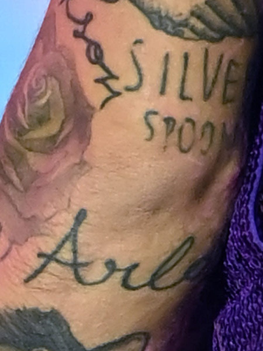 A tattoo of the name Arlo seen on Harry Styles' left arm.