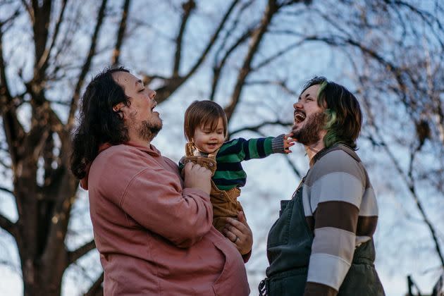 Joey, left, and Sam Guido hold their 16-month-old daughter in the backyard of their home in Janesville, Wisconsin.