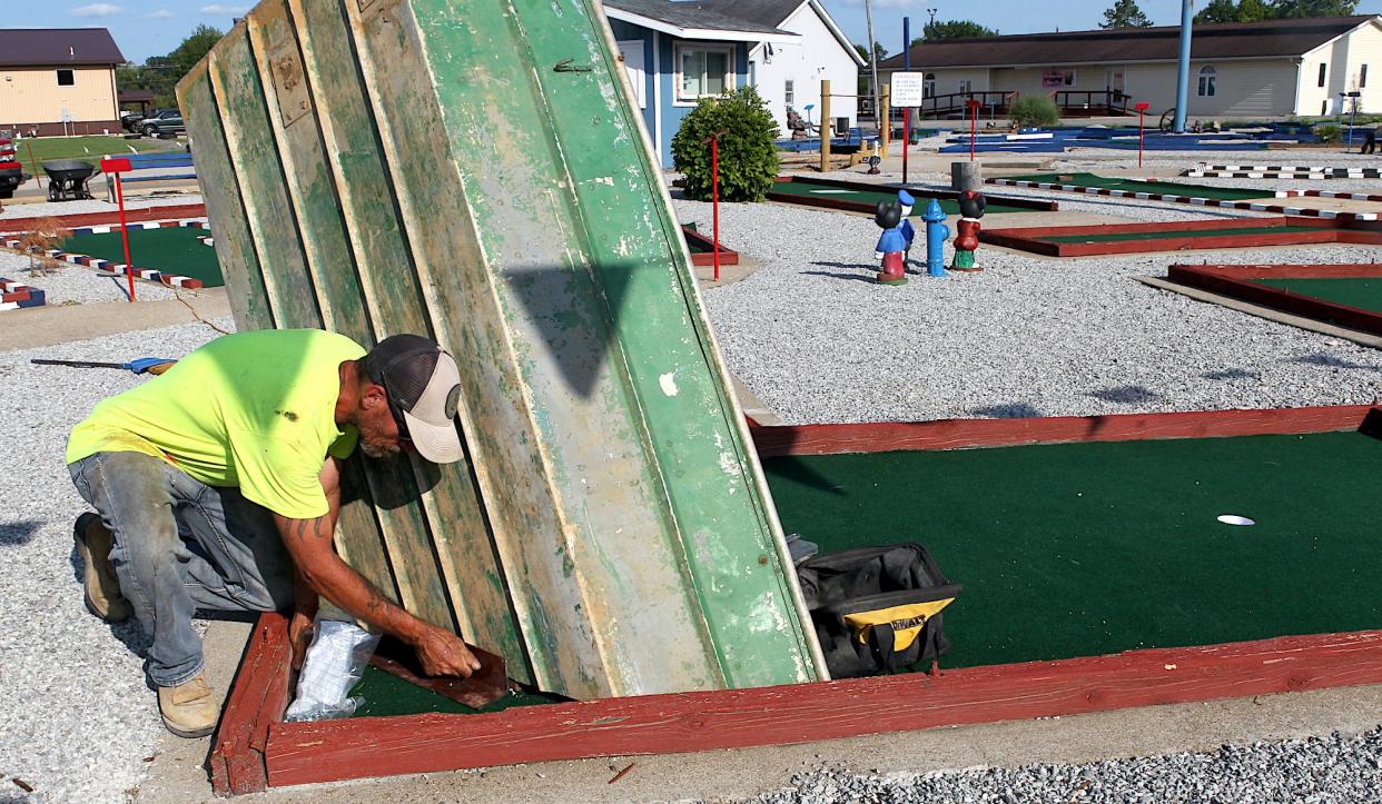 Mark Cain works on one of the greens at the future Freedom Fairway Miniature Golf Facility on Monday, July 31, 2023.