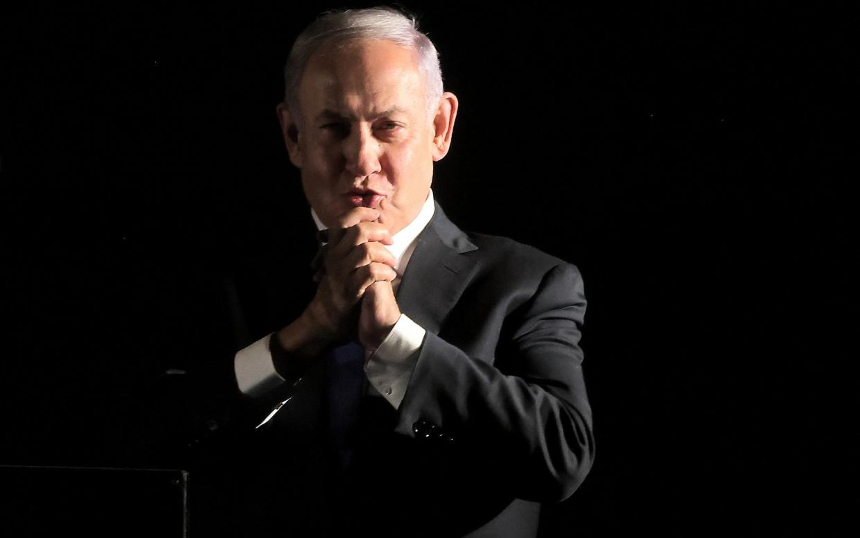 Benjamin Netanyahu gestures to supporters - MENAHEM KAHANA/AFP