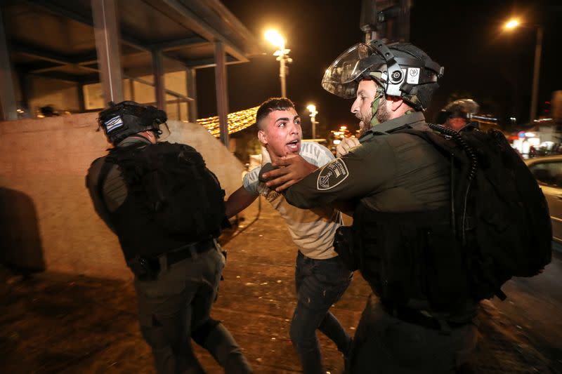 Israeli police detain a Palestinian at Jerusalem's Old City during clashes, as the Muslim holy fasting month of Ramadan continues, in Jerusalem