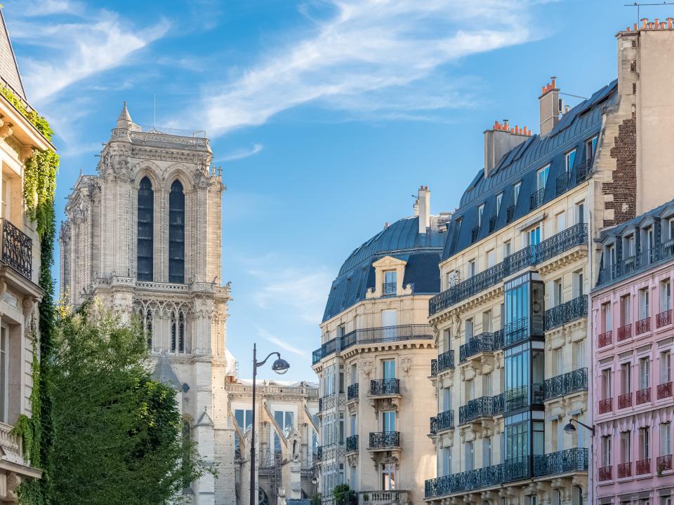 The colorful exterior facades of charming Parisian buildings in the Marais in Paris