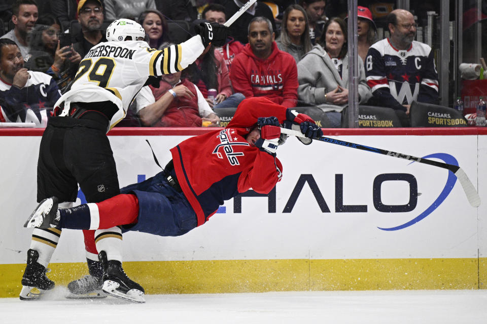 Boston Bruins defenseman Parker Wotherspoon (29) and Washington Capitals right wing Nicolas Aube-Kubel collide during the first period of an NHL hockey game, Monday, April 15, 2024, in Washington. (AP Photo/Nick Wass)