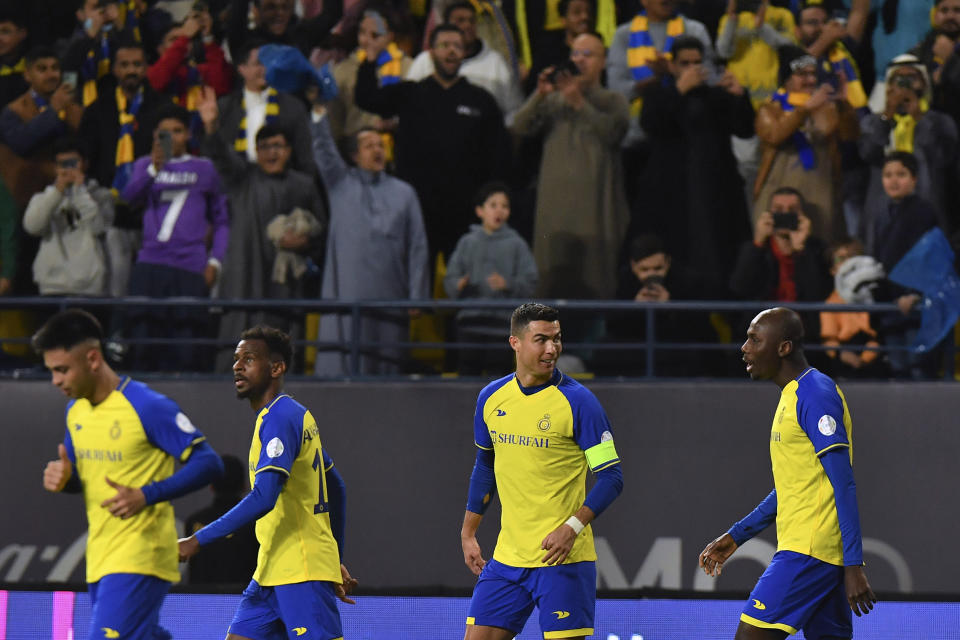 Al Nassr's Cristiano Ronaldo, second right, celebrates with teammates after Al Nassr's Anderson Talisca scored to 1-0 during the Saudi Pro League match between Al Ettifaq FC and Al Nassr FC at Mrsool Park Stadium, in Riyadh, Saudi Arabia, Sunday, Jan. 22, 2023. (AP Photo)