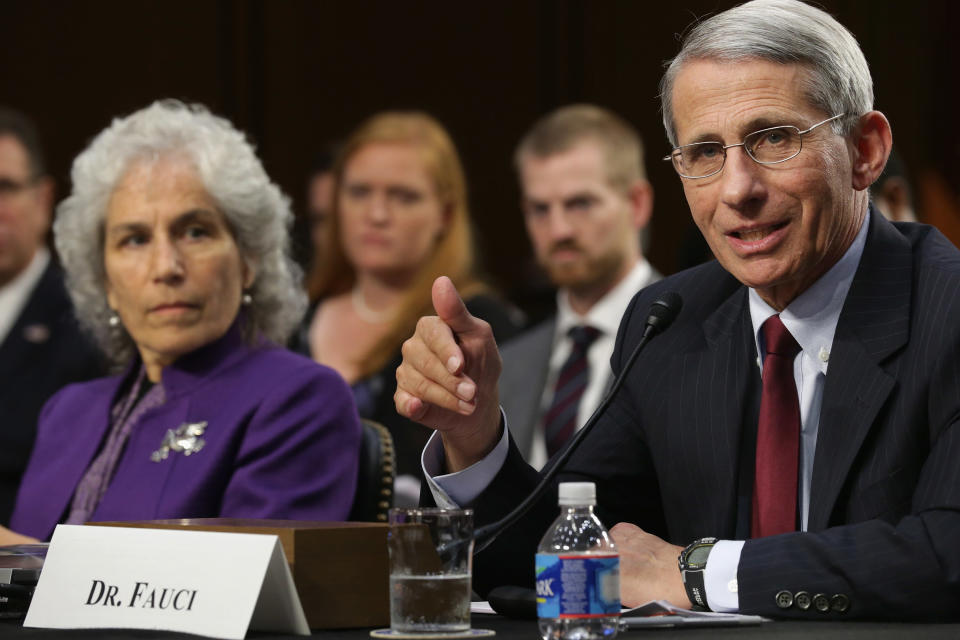 Anthony Fauci, with a nameplate saying: Dr. Fauci, testifies with Beth Bell at his side.