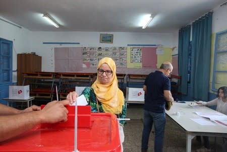 A woman casts her vote at a polling station in Tunis