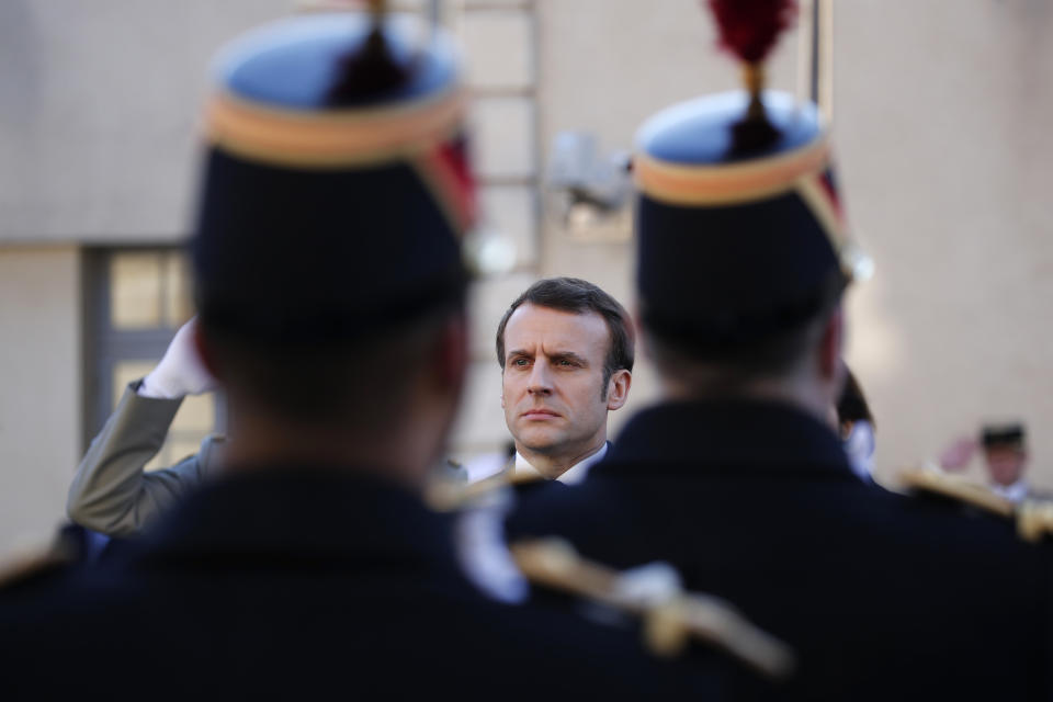 French President Emmanuel Macron reviews the troops before delivering a speech at the Ecole Militaire Friday, Feb. 7, 2020 in Paris. French President Emmanuel Macron, who leads the European Union's only post-Brexit nuclear power, on Friday advocated a more coordinated EU defense strategy in which France, and its arsenal, would hold a central role. (AP Photo/Francois Mori)