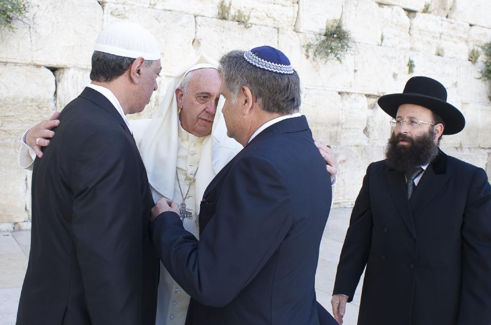 Pope Francis embraces Argentine Rabbi Skorka and Abboud in front of the Western Wall, Judaism's holiest prayer site, in Jerusalem's Old City