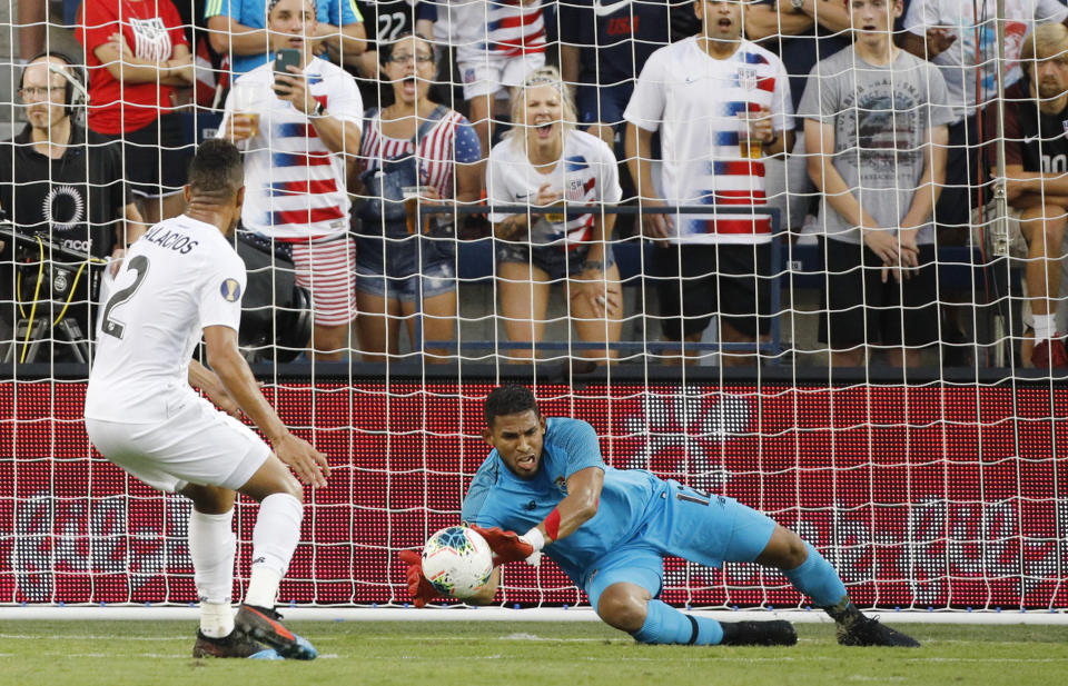 Panama goalkeeper Jose Calderon (12) blocks a shot against the United States as defender Francisco Palacios (2) watches during the first half of a CONCACAF Gold Cup soccer match in Kansas City, Kan., Wednesday, June 26, 2019. (AP Photo/Colin E. Braley)