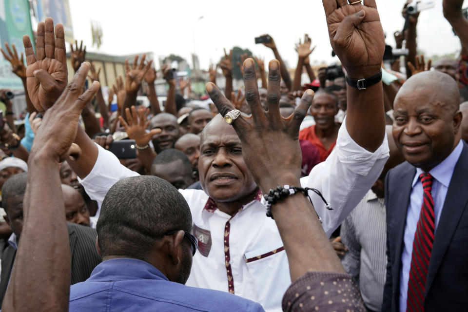 Spurned Congo opposition candidate Martin Fayulu greets supporters as he arrives at a rally in Kinshasha, Congo, Friday, Jan. 11, 2019. Hundreds gathered to denounce what they called "the people's stolen victory" in the presidential election. (AP Photo/Jerome Delay)