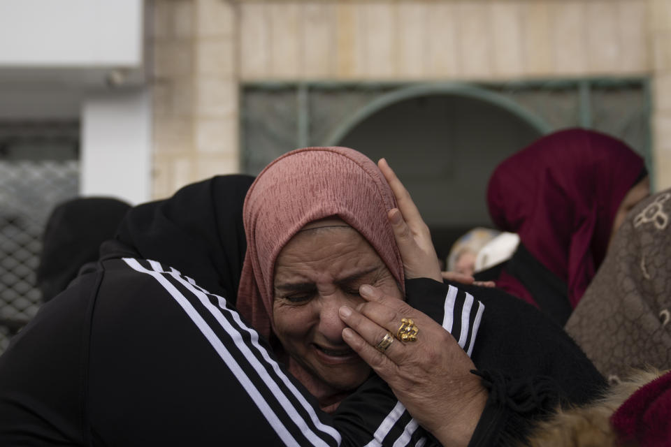 Palestinian women cry after taking the last look at the body of Suleiman Kanan, 17, during his funeral in the West Bank town of Bir Zeit, Monday, Jan. 15, 2024. Palestinian Health Ministry said that Suleiman Kanan, 17, and Khaled Humeidat, 16, were killed by Israeli army fire last night near the northern entrance of Ramallah. Humeidat's body was not released to his family by the Israeli army. The Israeli army said troops of the 636th Combat Intelligence Collection unit carrying out "proactive activity" near Ramallah killed two suspects hurling a bomb at the army base. (AP Photo/Nasser Nasser)