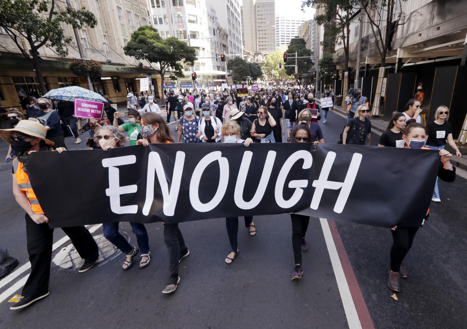 Thousands of people with placards and banners rally demanding justice for women in Sydney, Monday, March 15, 2021, as the government reels from two separate allegations. The rally was one of several across Australia including in Canberra, Melbourne, Brisbane and Hobart calling out sexism, misogyny and dangerous workplace cultures. (AP Photo/Rick Rycroft)