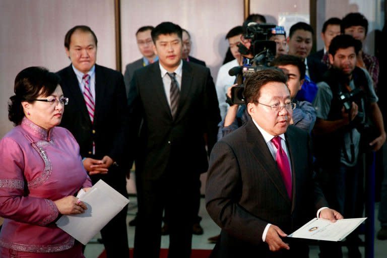 Mongolian President Tsakhia Elbegdorj (far right) votes at a polling station in Ulan Bator, on June 26, 2013. Mongolians are voting in a presidential election pitting the front-running incumbent against a champion wrestler and a woman, amid calls for a fairer distribution of the former Soviet satellite's spectacular mining wealth