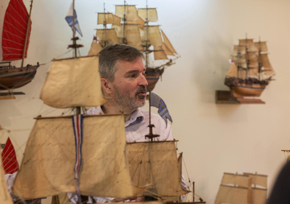 Owner, Grégory Postel inspects a model ship at the Le Village model ship making company in Antananarivo, Madagascar, Wednesday, Sept. 11, 2024. (AP Photo/Alexander Joe)