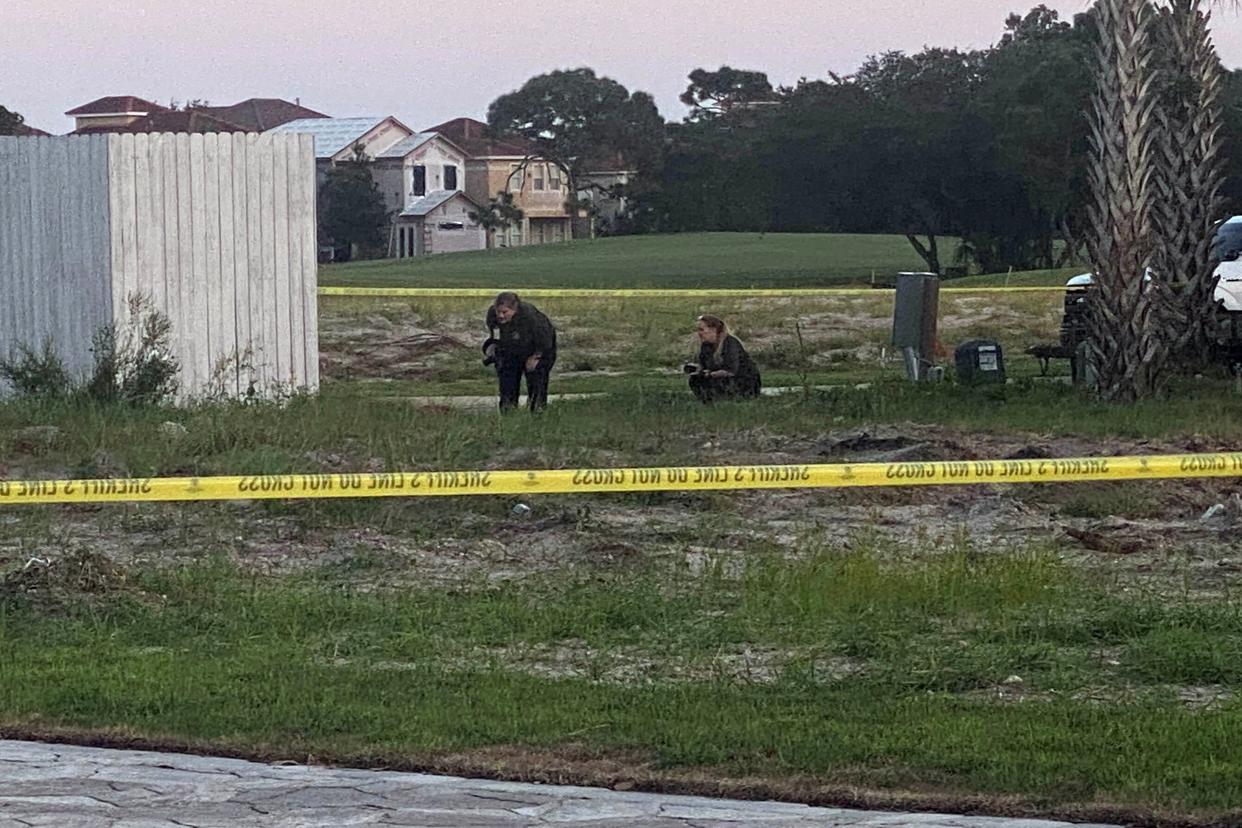 Okaloosa County Sheriff's Office personnel investigate a crime scene in Regatta Bay, where deputies responding to an armed disturbance killed 45-year-old Berlin Gonzalez, after he fired upon them and civilians on the scene.