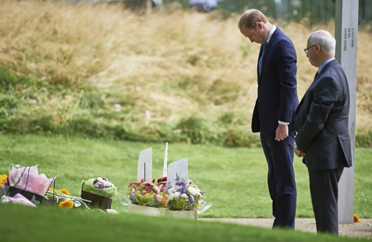 Britain's Prince William, Duke of Cambridge (L), lays flowers at the 7/7 memorial in London's Hyde Park on July 7, 2015