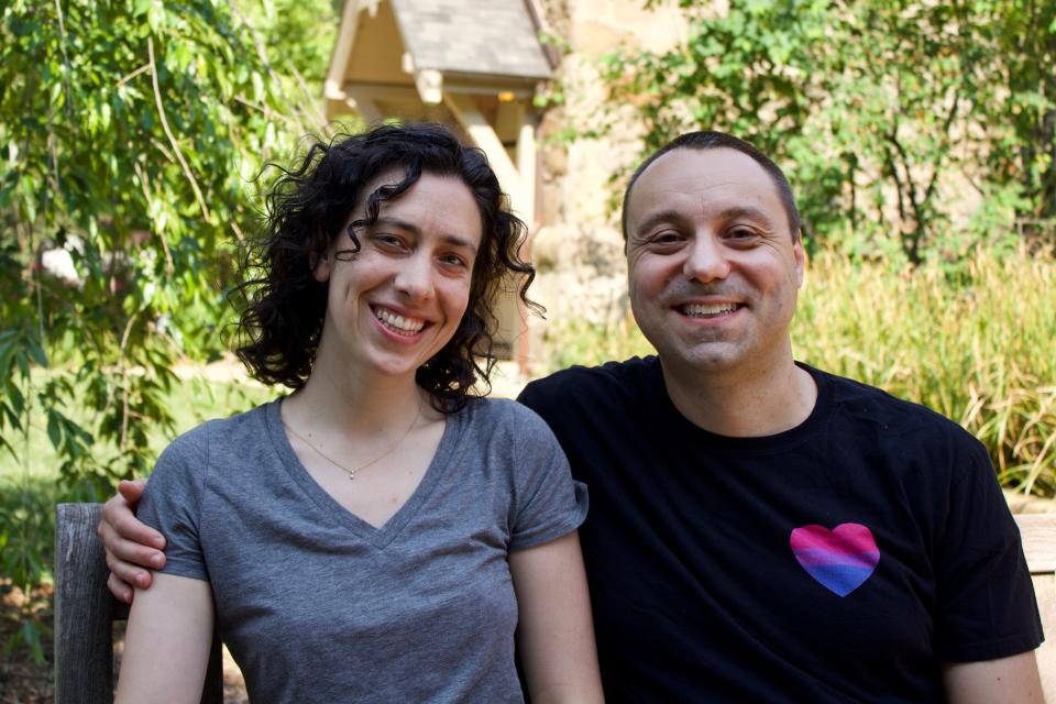 David Reznik, wearing a bisexual pride shirt, sits with his, partner, Gretchen York, in northwest Washington, D.C.