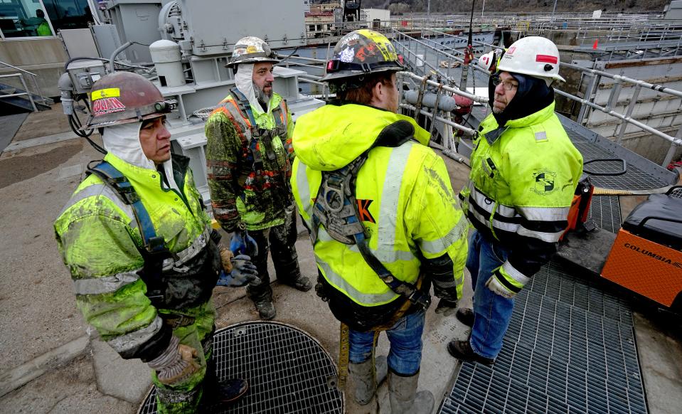 Maintenance foreman Mike Gunderson, right, talks with workers at Lock and Dam No. 2 Jan. 30 on the Mississippi River in Hastings, Minnesota. The crew has until March 5 to get repairs done on the lock chamber.