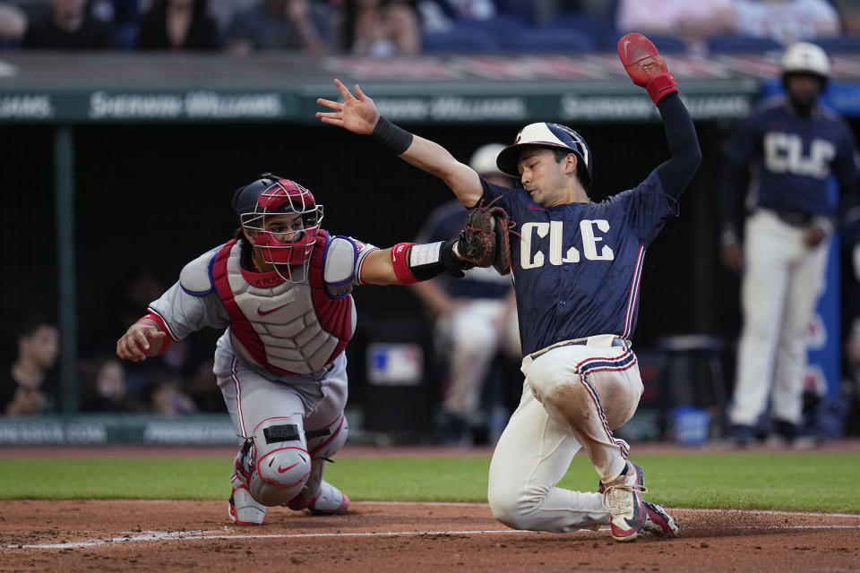 Washington Nationals catcher Keibert Ruiz, left, tags out Cleveland Guardians' Steven Kwan at home plate during the fifth inning of a baseball game Friday, May 31, 2024, in Cleveland. (AP Photo/Sue Ogrocki)