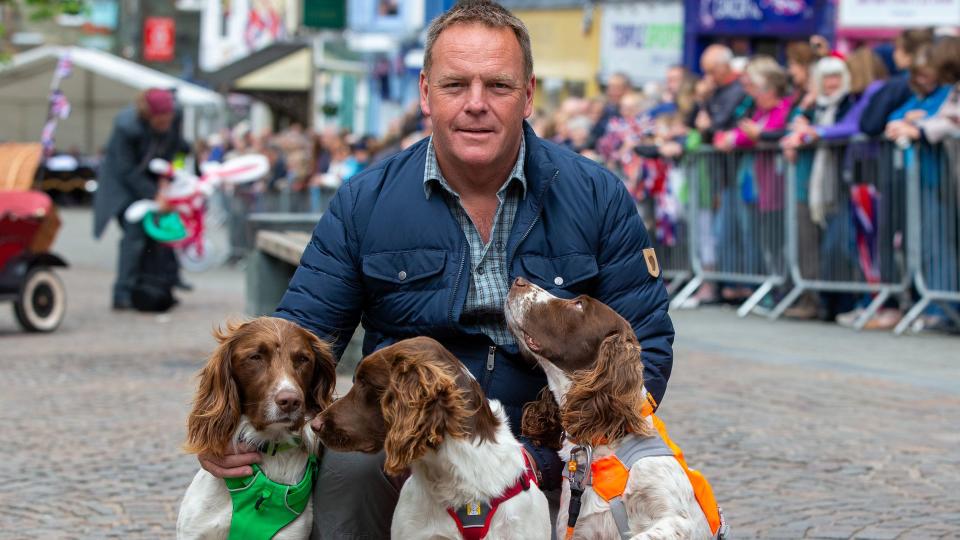 Kerry Irving poses with his three dogs Max, Paddy, and Harry after he met Prince William, Duke of Cambridge and Catherine, Duchess of Cambridge as they visit Keswick Market place during a visit to Cumbria on June 11, 2019 in Keswick, England