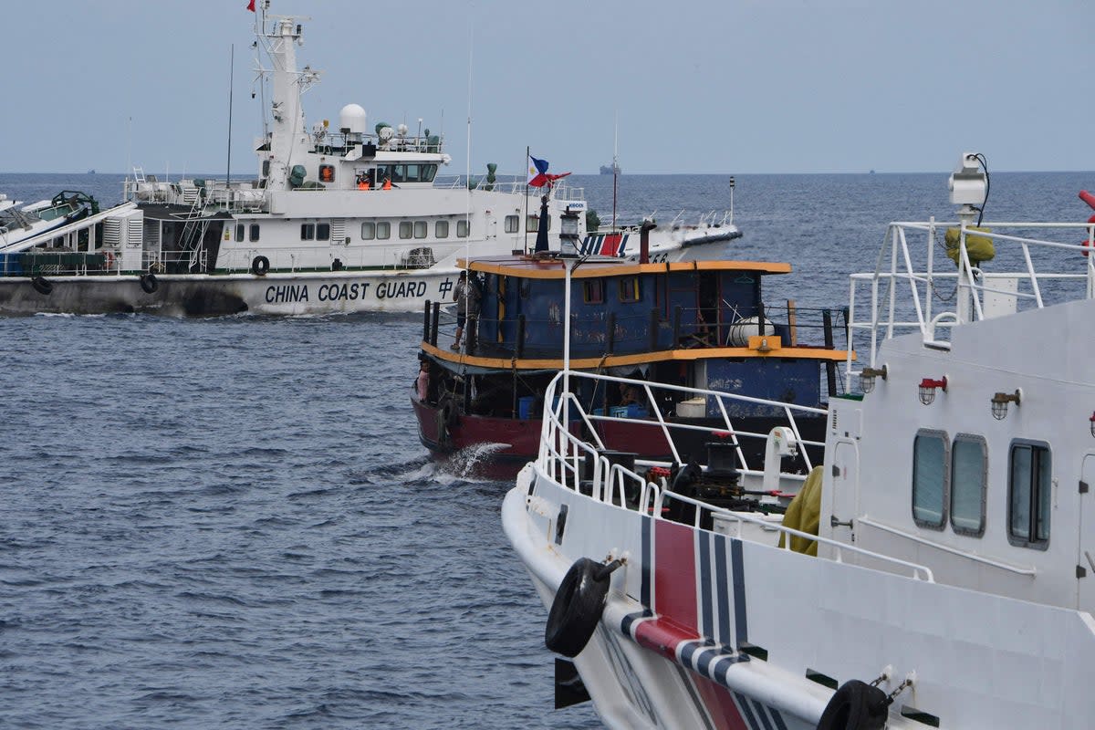 File Chinese coast guard ships and a corral a Philippine civilian boat chartered by the Philippine navy to deliver supplies to Philippine navy ship BRP Sierra Madre in the disputed South China Sea, on 22 August 2023 (AFP via Getty Images)